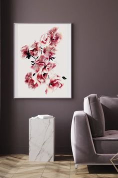 a living room with a gray couch and white marble side table in front of a painting on the wall