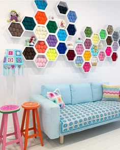 a living room filled with furniture and lots of colorful hexagonals on the wall