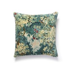 a green and blue pillow with flowers on it