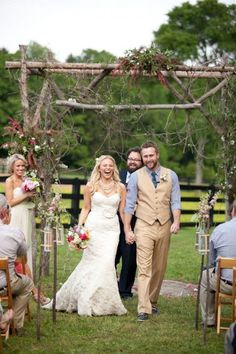 a bride and groom walking down the aisle