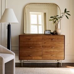 a large mirror sitting on top of a wooden dresser