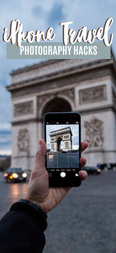 someone taking a photo of the arc de trioe in paris with their cell phone