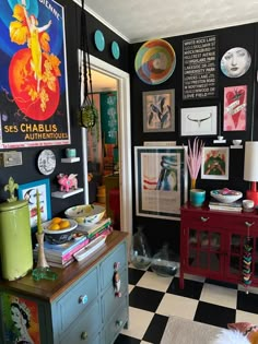 a black and white checkered floor in a room with posters on the wall above it