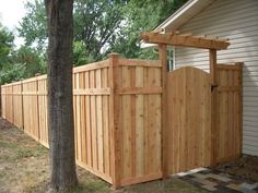 a wooden fence in front of a house