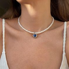 This choker is made from natural freshwater pearls. The pendant with a blue crystal looks very striking. The necklace is a perfect gift for a friend. Its design adds a romantic touch to the look and helps create an extraordinary appearance. Beads: Natural freshwater pearls. Clasp: Stainless Steel. Pendant: Copper, Glass Pendant size: 1,7cm*1,6cm. Necklace length 39сm+5cm. 🔸more from us🔸 https://www.etsy.com/shop/DoraJewelryAccessory Blue Stone Pendant, Romantic Necklace, Real Pearl Necklace, Copper Glass, Necklace Heart, Gift For Woman, Real Pearls, Stone Pendant Necklace, Stone Heart