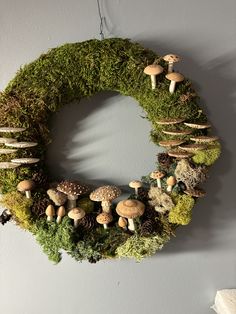 a wreath made out of moss and mushrooms