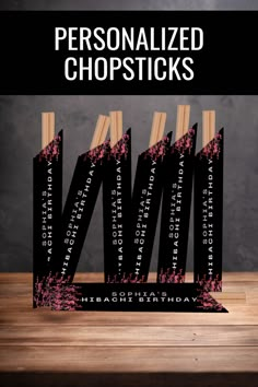 the personalized chopsticks are set on top of each other, with pink and black designs