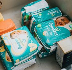 baby diapers stacked on top of each other next to boxes of tissues and bottles