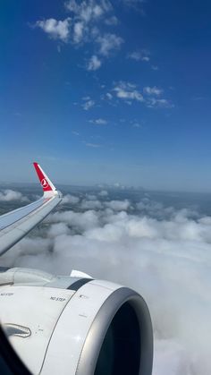 an airplane wing flying above the clouds