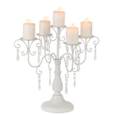 a white candle holder with five candles in it