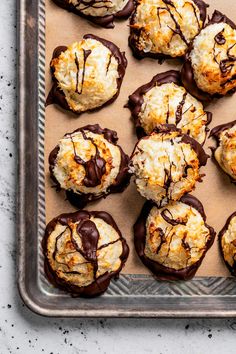 chocolate dipped coconut cookies on a baking sheet