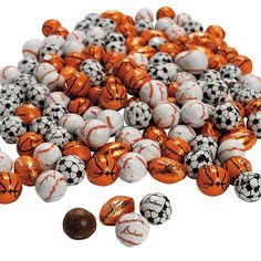 a pile of orange and white balls next to a chocolate ball