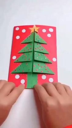 someone is making a christmas tree out of paper