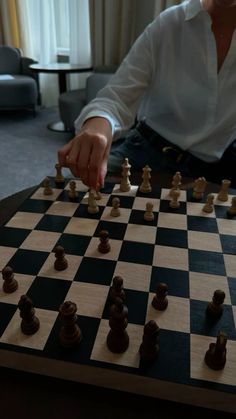 a man sitting at a table playing chess