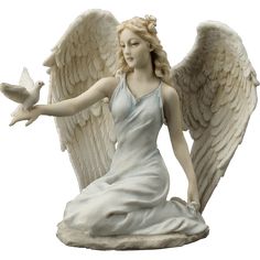 a statue of an angel holding a dove in her hand and sitting on the ground