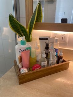 a wooden tray holding various items in front of a mirror