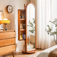 a mirror sitting on top of a wooden dresser next to a bed in a bedroom