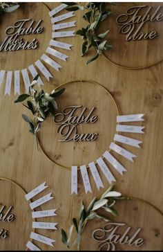 the table is set up with place cards and greenery on it for guests to write their names