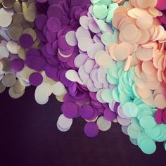 there are many different colors of confetti on the table