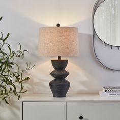 This exquisite table lamp boasts a beautifully distressed black ceramic base that infuses your bedside or foyer table with timeless elegance, balancing classic charm and modern transition in perfect harmony. The matching finish gracefully flows to the finial and base, crafting a stunningly cohesive silhouette that radiates sophistication. Draped in a warm beige fabric shade, this lamp casts a gentle, inviting light from an E26 LED bulb (not included), creating an atmosphere of comfort. KAWOTI 25 Chunky Table, Beige Lamp, Pottery Lamps, Beige Lamps, Black Table Lamp, Black Pottery, Pottery Lamp, Foyer Table, Fixture Table