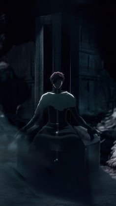 a woman sitting on a chair in the dark