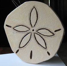 a white stone with an intricate design on it