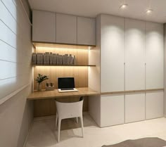 a computer desk sitting under a window next to a white chair and bookshelf