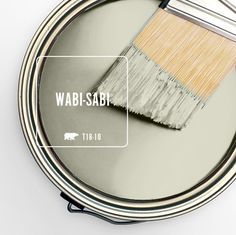 a paint can with a brush in it and the words wabi - sabi above it