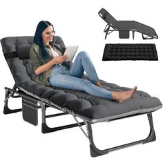 a woman sitting in a reclining chair using a laptop