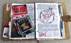 an open notebook with drawings and writing on it