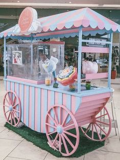 a pink and blue ice cream cart on display