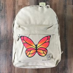 Everest Khaki Canvas Laptop Backpack With Hand Painted Butterfly. New. Medium Sized Main Compartment With A Zip Around Closure, Padded Laptop Compartment And Plenty Of Additional Storage For Books, Folders Or Clothing. Front Zipper Pocket Offers Convenient Storage For Cell Phone, Keys Etc. 13” X 11.75” X 1” Laptop Compartment 16.5” X 13” X 6.5” Total Bag Dimensions. Each Item Is Individually Hand Painted By Me. Customized Backpack Ideas, Hand Painted Backpack, Painting On School Bag, Beige Casual Standard Backpack, Casual Beige Standard Backpack, Beige Backpack For Back To School, Beige Backpack For Everyday Use And Back To School, Beige On-the-go Bag For Back To School, Casual Beige Backpack For Everyday Use