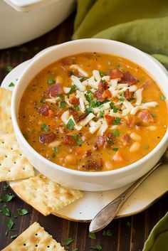 a bowl of soup with tortilla crackers on the side