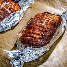 two pieces of meat wrapped in tin foil