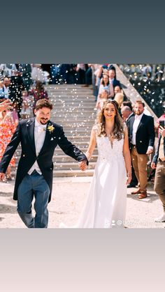 a bride and groom walking down the aisle with bubbles in the air as they exit their wedding ceremony