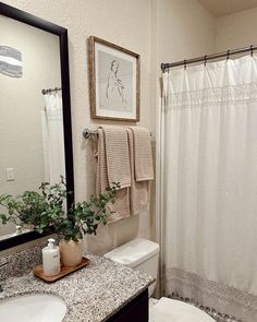 a bathroom with a sink, toilet and mirror