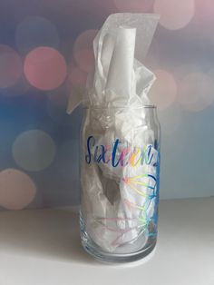 a clear glass with tissue paper in it