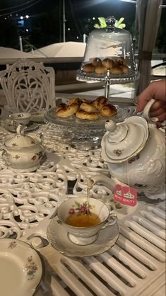 a table topped with plates and cups filled with food