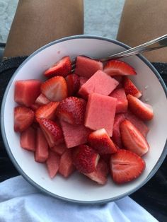 a white bowl filled with sliced up strawberries