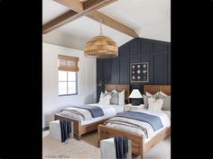 two beds in a room with wooden beams