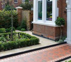 a brick house with white trim and windows