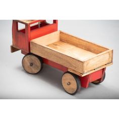 a small wooden toy truck with wheels