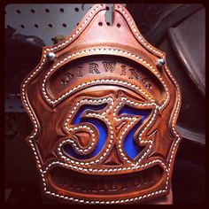 a brown leather sign with the number 55 on it