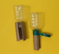 there are two plastic objects made to look like toothbrushes on the yellow background