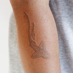 a man with a tattoo on his arm that has a starfish in it's stomach