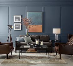 a living room with blue walls and leather furniture