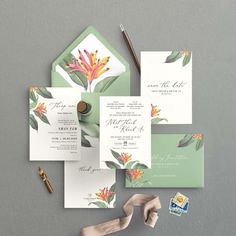 the wedding stationery is laid out on top of each other, including an envelope and matching card