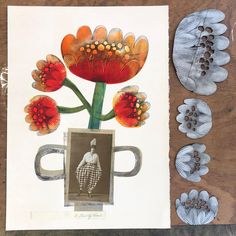 an art work with flowers and coffee mugs on a wooden table next to paper cut outs