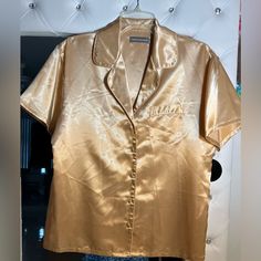 Valerie Stevens Gold Short Sleeve Pajama Sleep Top In 100% Polyester, Made In Hong Kong. Snazzy For Bedtime, And Sleek As Satin.Front Pocket And Fabric Covered Buttons. Go For The Gold! Bnwt Size S Msrp Is $36 Gold Shorts, Fabric Covered Button, Pajama Top, Short Sleeve Button, Fabric Covered, Covered Buttons, Women's Intimates, Front Pocket, Hong Kong