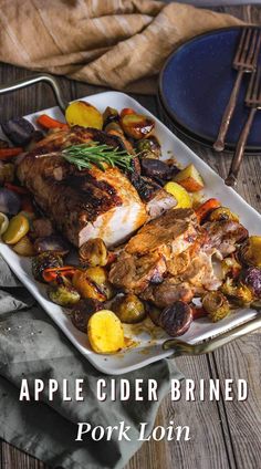 a white plate topped with chicken, potatoes and carrots on top of a wooden table